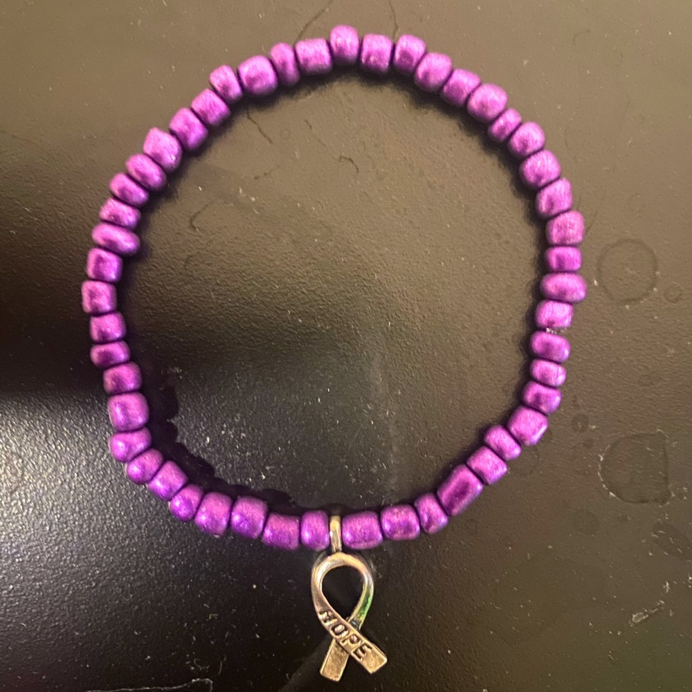 Handmade purple awareness bracelet with silver medallion
